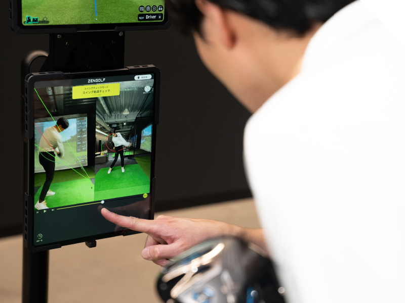 スイング映像をタブレットで確認する様子
